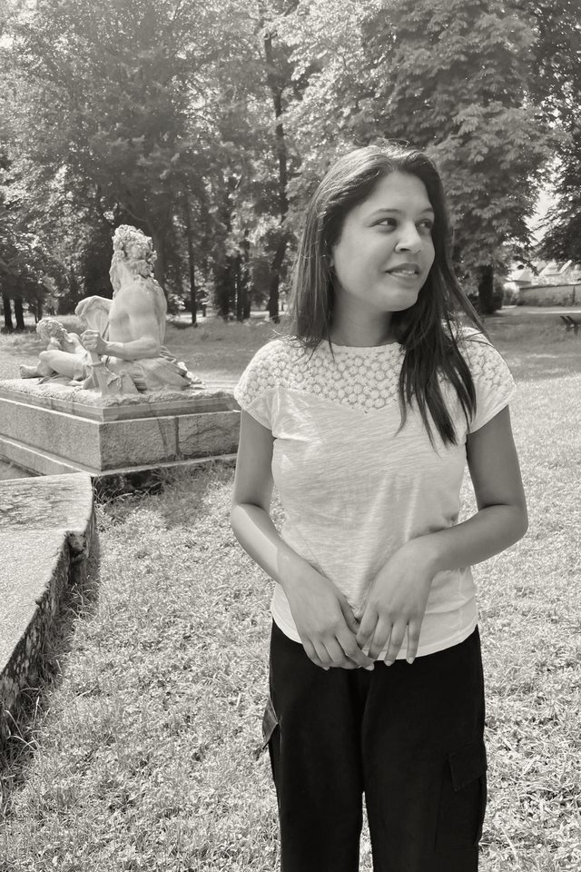Donna, who teaches at Yoga in the North, standing outdoors in a Paris park.